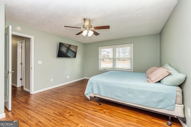 bedroom with ceiling fan and wood-type flooring