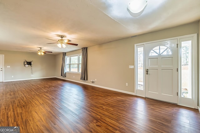 foyer entrance featuring dark hardwood / wood-style flooring, ceiling fan, and a healthy amount of sunlight