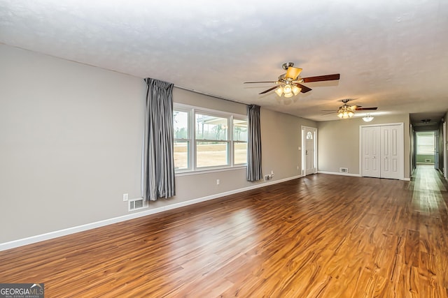 spare room with hardwood / wood-style floors and ceiling fan