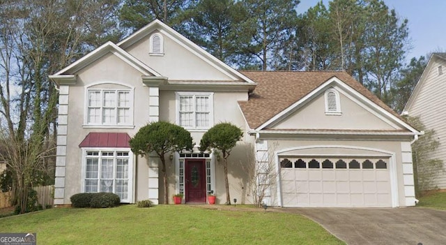 view of front of house with a front yard and a garage