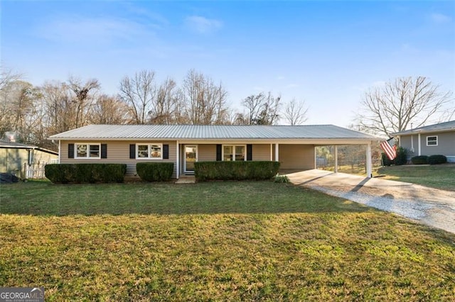 ranch-style house featuring a front lawn and a carport