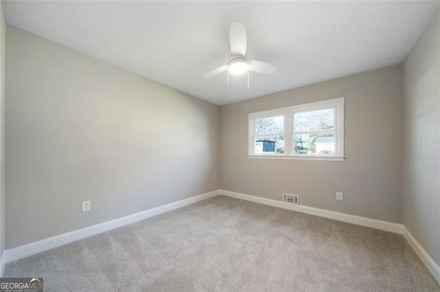 unfurnished room featuring ceiling fan and light carpet