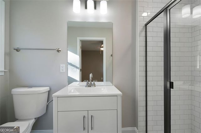 bathroom featuring vanity, toilet, and walk in shower