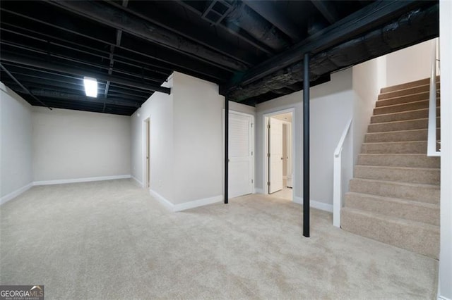 basement featuring light carpet