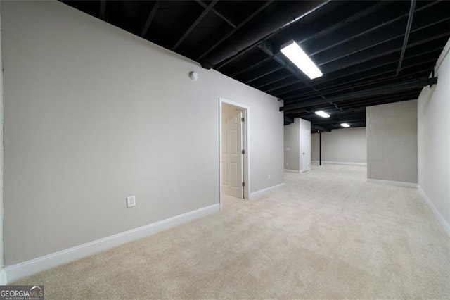 basement featuring light carpet