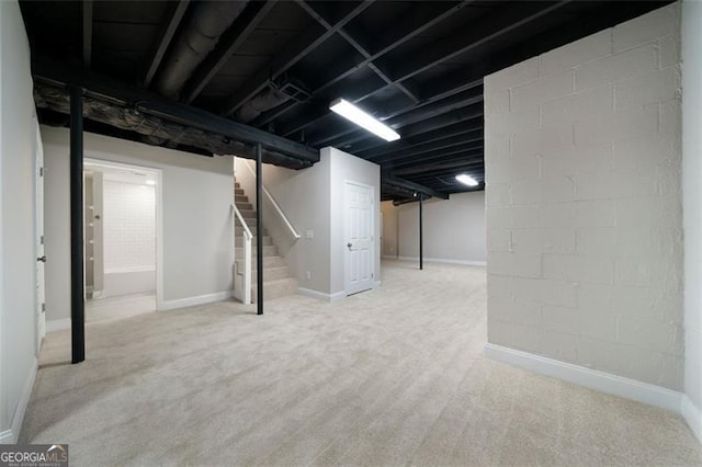 basement featuring light colored carpet