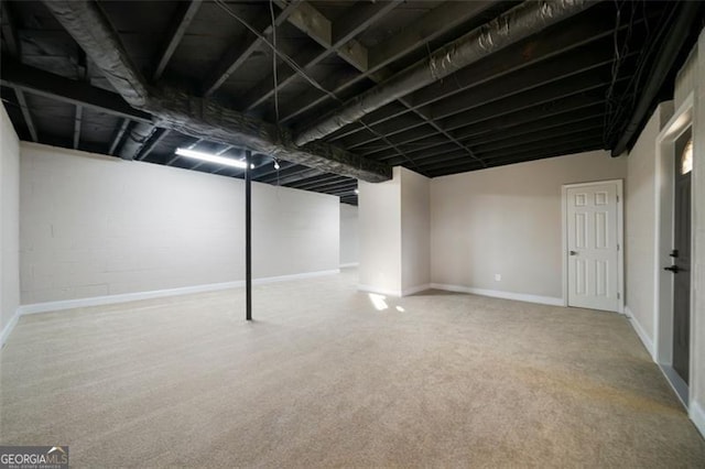 basement featuring light colored carpet