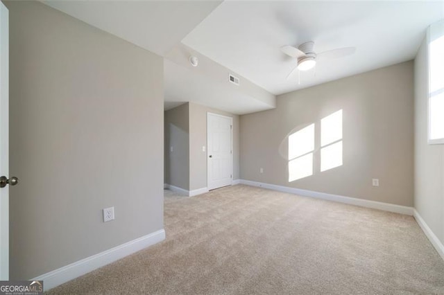 empty room with light carpet and ceiling fan