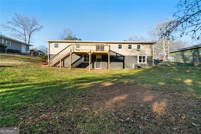 rear view of house with a yard and a deck