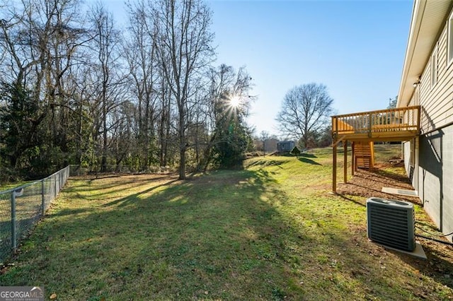 view of yard with central AC unit and a wooden deck