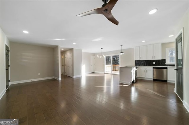 kitchen with dishwasher, tasteful backsplash, decorative light fixtures, dark hardwood / wood-style flooring, and white cabinetry