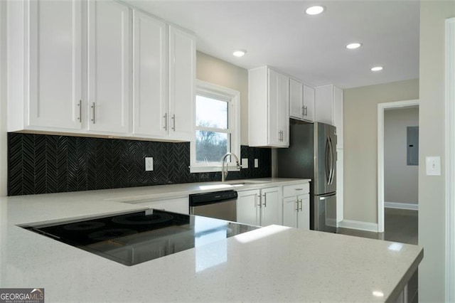 kitchen featuring appliances with stainless steel finishes, light stone counters, sink, electric panel, and white cabinetry