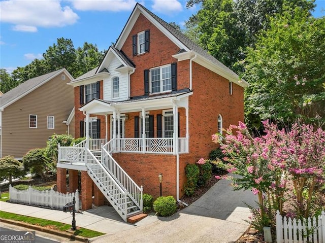 2750 Olde Towne Pkwy, Duluth, GA 30097 - traditional home with a porch, brick siding, and stairway