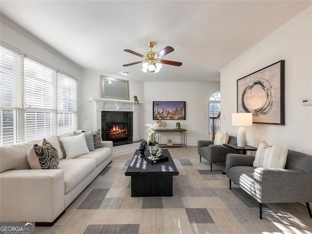 carpeted living room with ceiling fan and ornamental molding