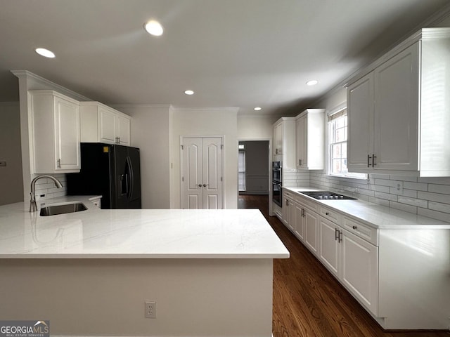 2750 Olde Towne Pkwy, Duluth, GA 30097 - kitchen featuring black appliances, a sink, a peninsula, tasteful backsplash, and white cabinetry