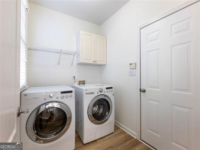2750 Olde Towne Pkwy, Duluth, GA 30097 - laundry room with washer and dryer, cabinet space, light wood-type flooring, and baseboards