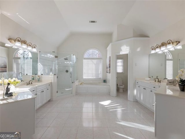 full bathroom featuring vanity, vaulted ceiling, tile patterned flooring, toilet, and independent shower and bath