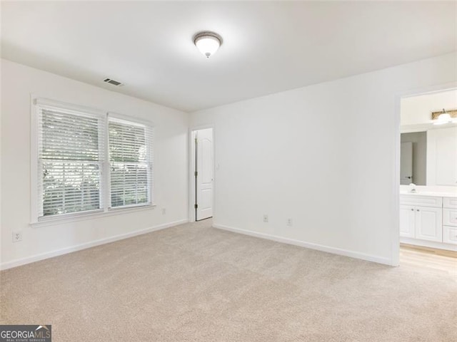 unfurnished room with light colored carpet