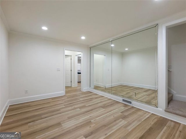 2750 Olde Towne Pkwy, Duluth, GA 30097 - unfurnished bedroom with light wood-style flooring, recessed lighting, baseboards, a closet, and crown molding