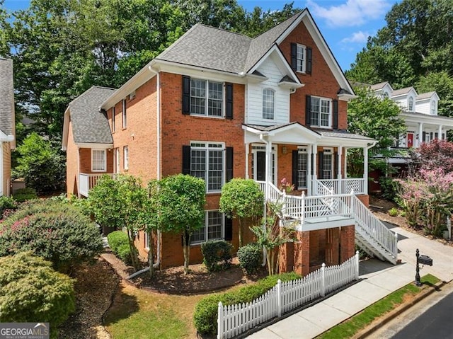 2750 Olde Towne Pkwy, Duluth, GA 30097 - view of front of house featuring brick siding, a porch, stairs, and roof with shingles