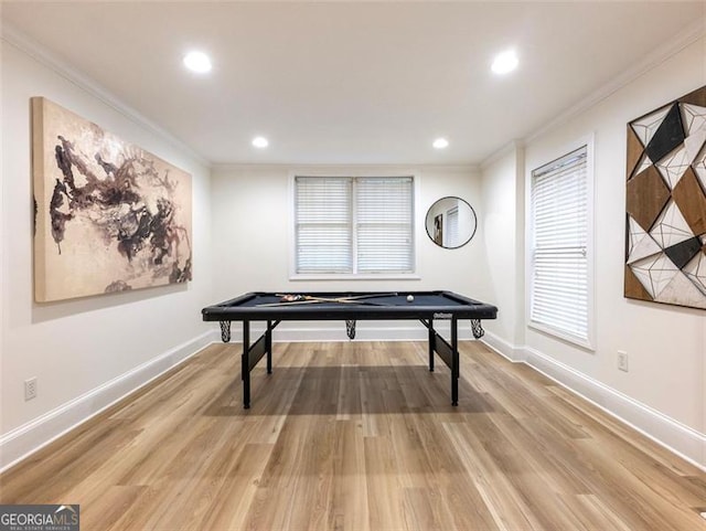 recreation room featuring wood-type flooring and ornamental molding