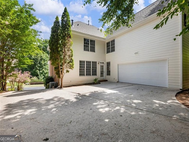 2750 Olde Towne Pkwy, Duluth, GA 30097 - rear view of property featuring a garage, concrete driveway, and central air condition unit