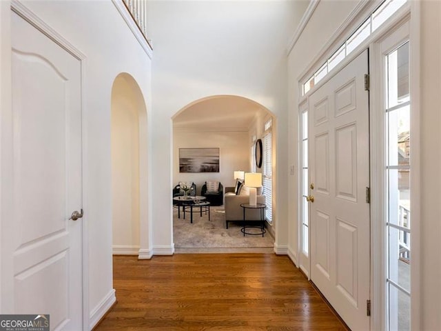 2750 Olde Towne Pkwy, Duluth, GA 30097 - foyer with arched walkways, wood finished floors, baseboards, a high ceiling, and ornamental molding