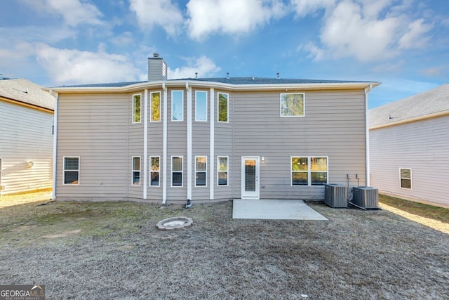 rear view of property featuring central air condition unit and a patio