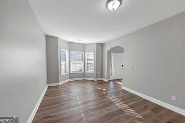 unfurnished room with dark hardwood / wood-style floors