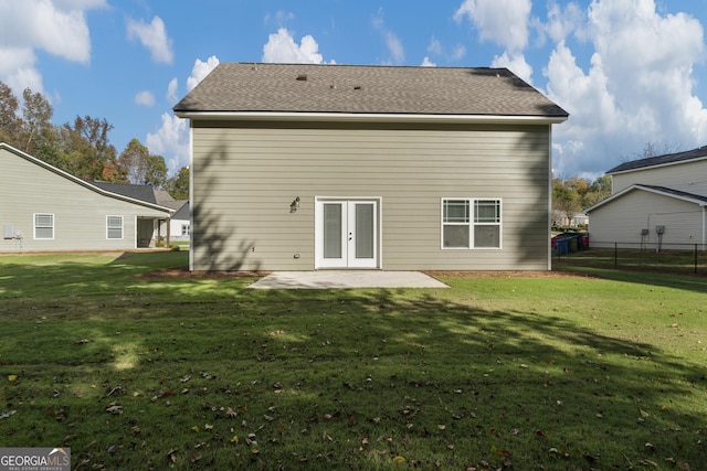 back of property with a yard, a patio, and french doors