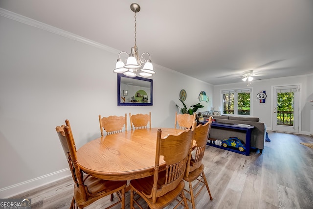 dining room featuring ceiling fan with notable chandelier, light hardwood / wood-style flooring, and ornamental molding