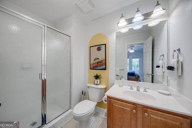 bathroom featuring vanity, toilet, tile patterned flooring, and walk in shower