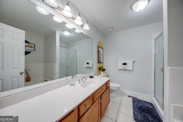 full bathroom featuring toilet, tile patterned floors, vanity, and separate shower and tub