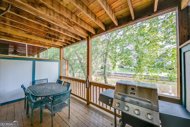 sunroom featuring beamed ceiling