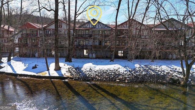 view of snow covered rear of property