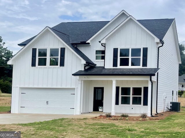 modern farmhouse style home with a front lawn, a garage, and cooling unit