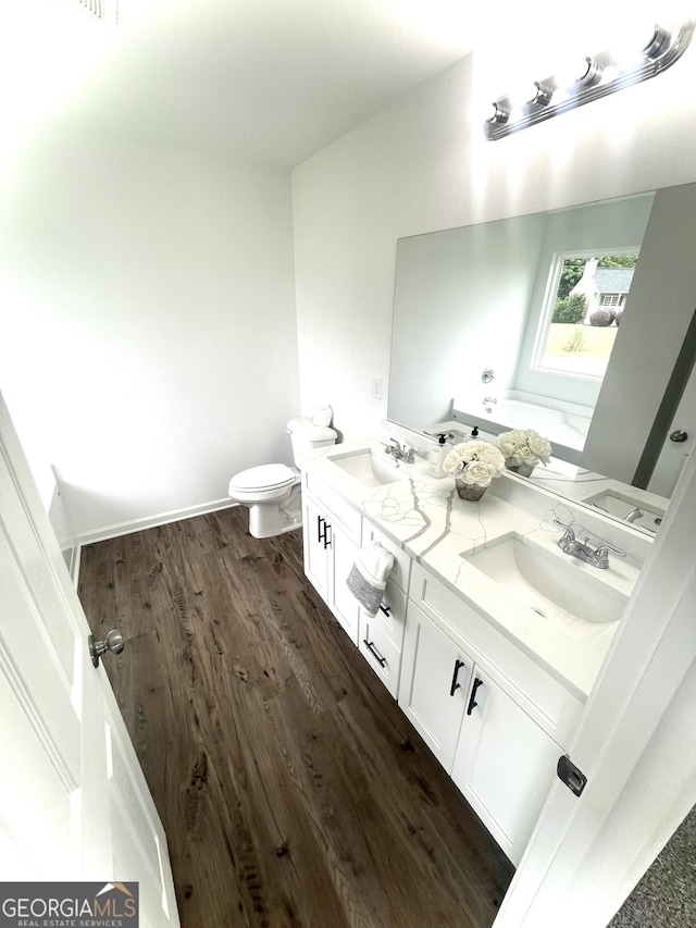 bathroom featuring hardwood / wood-style floors, vanity, and toilet