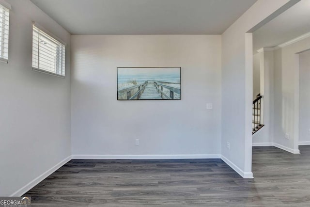 empty room with dark hardwood / wood-style flooring