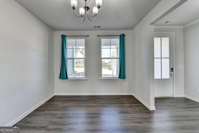 unfurnished dining area with a chandelier and dark hardwood / wood-style flooring