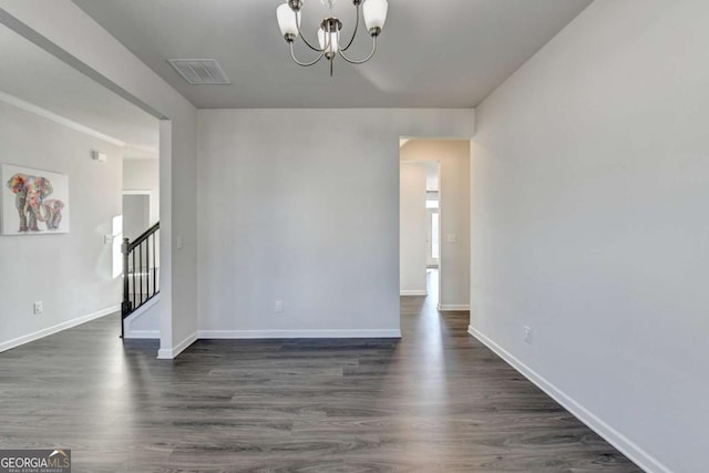 interior space featuring dark hardwood / wood-style floors and an inviting chandelier