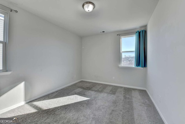 unfurnished room featuring carpet