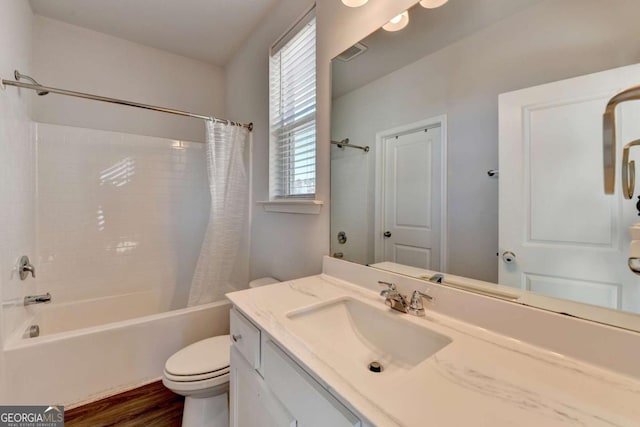 full bathroom featuring vanity, toilet, wood-type flooring, and shower / bath combo