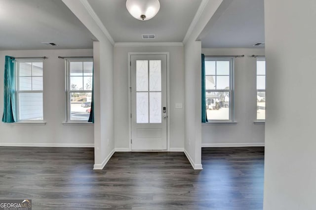 entrance foyer with dark hardwood / wood-style floors and ornamental molding