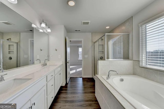 bathroom featuring wood-type flooring, vanity, and independent shower and bath