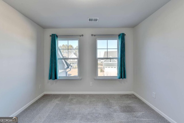 unfurnished room featuring light carpet