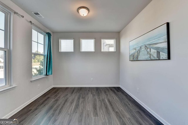 empty room featuring dark wood-type flooring