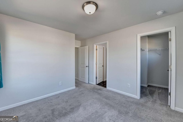 unfurnished bedroom with carpet flooring and a closet