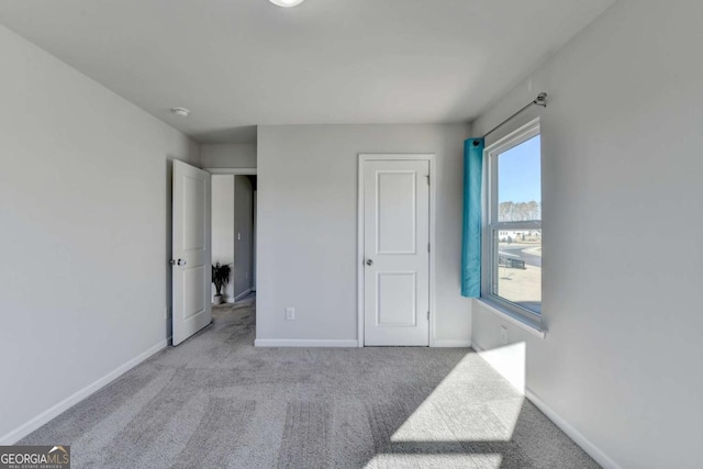 unfurnished bedroom featuring light carpet