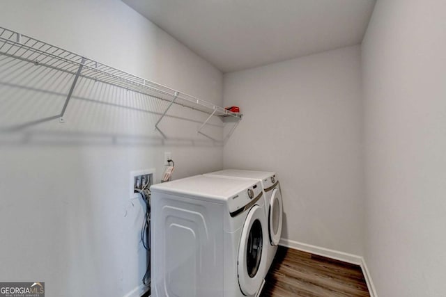 laundry room with separate washer and dryer and dark wood-type flooring