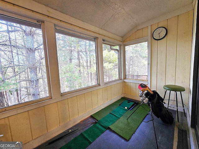 sunroom / solarium featuring lofted ceiling